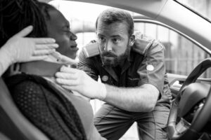 man helping a car accident victim
